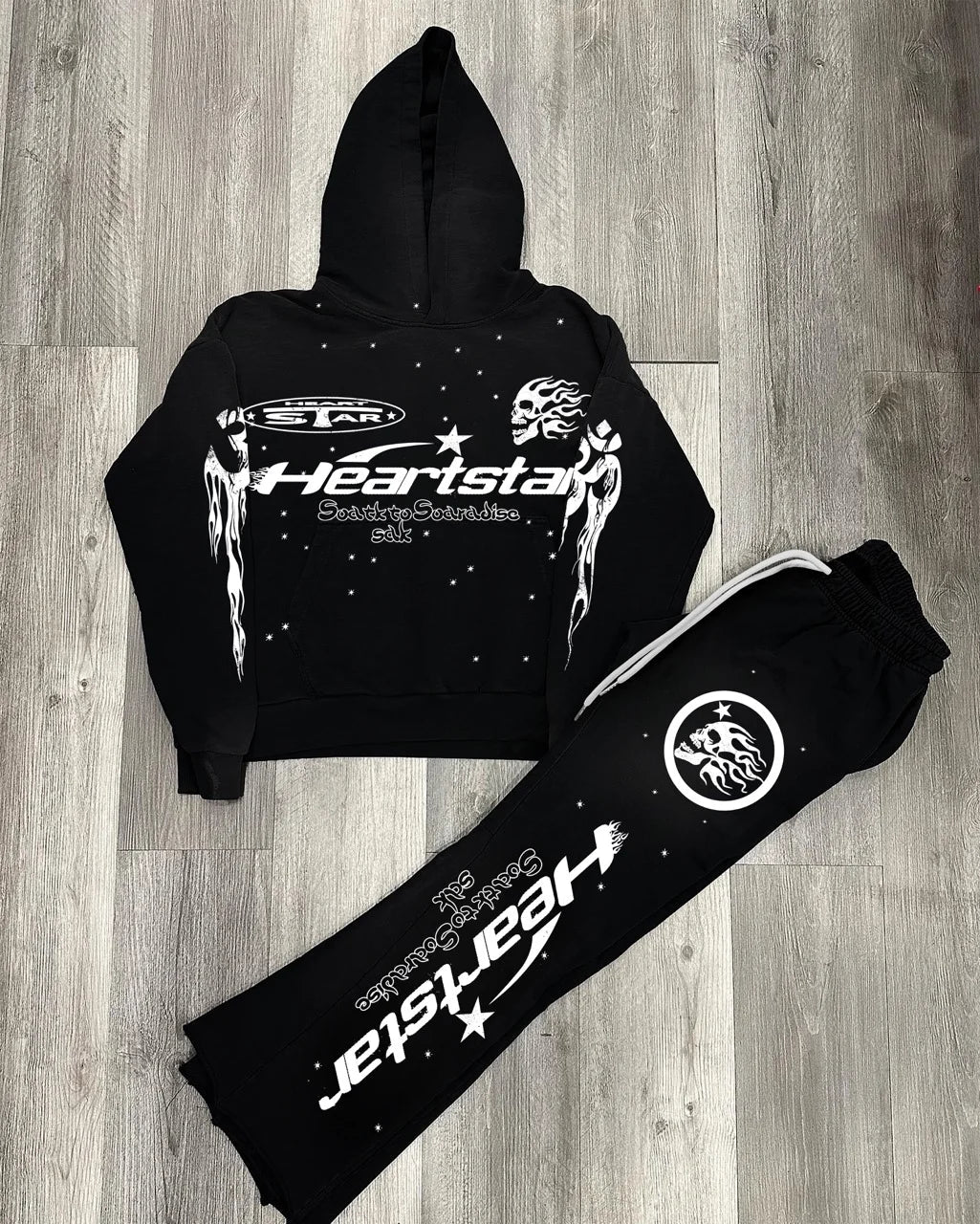 Black hoodie and pants set with 'Heartstar' branding on a wooden floor.