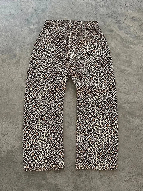 Leopard print pants on a gray concrete surface