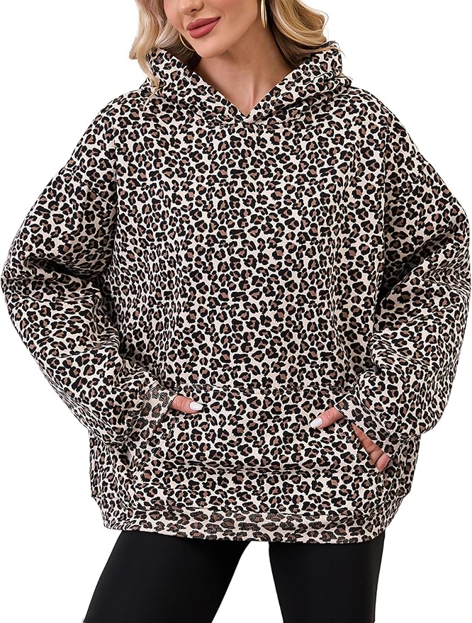 Person wearing a leopard print hoodie on a white background