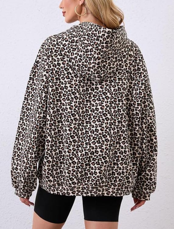 Person wearing a leopard print jacket on a plain background