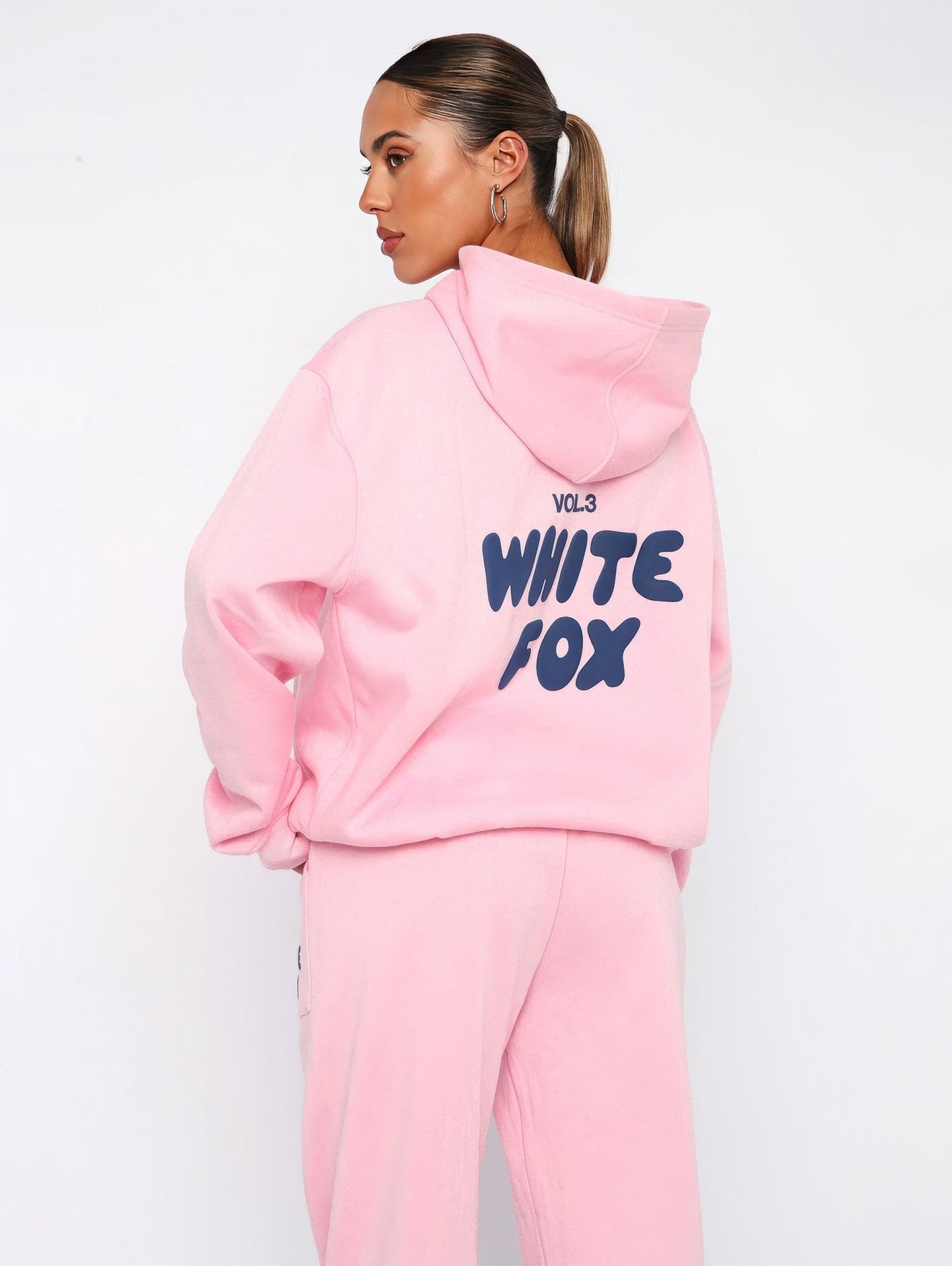 Person wearing a pink hoodie with 'White Fox' text on a white background