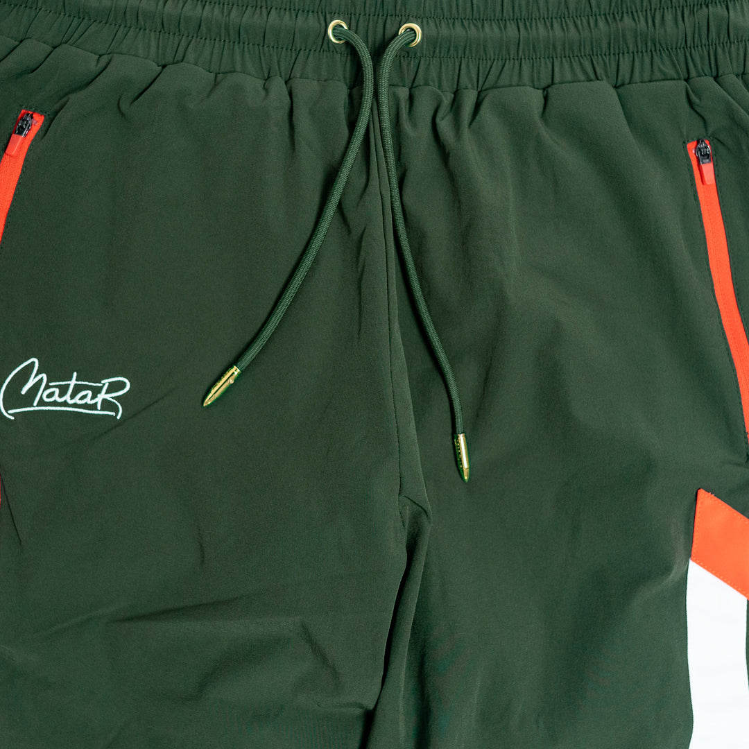 Green shorts with red accents and a logo on a white background