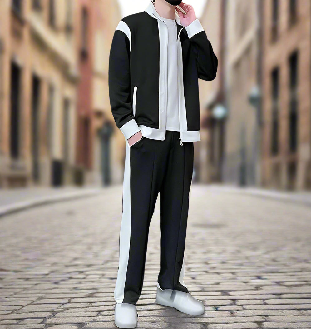 Person wearing a black and white outfit on a blurred street background