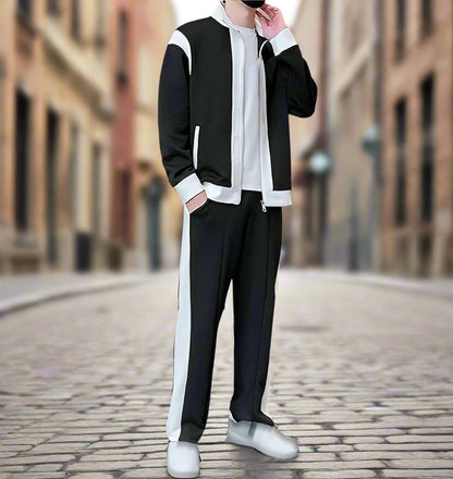Person wearing a black and white outfit on a blurred street background