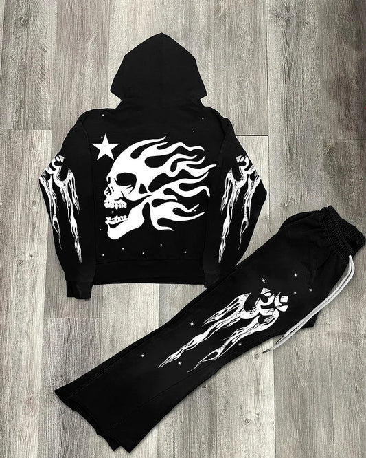Black hoodie and pants set with white skull and flame design on a wooden floor.