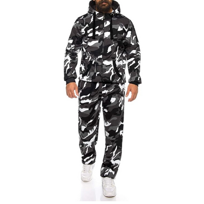 Person wearing a black and white camouflage jacket and pants set on a white background