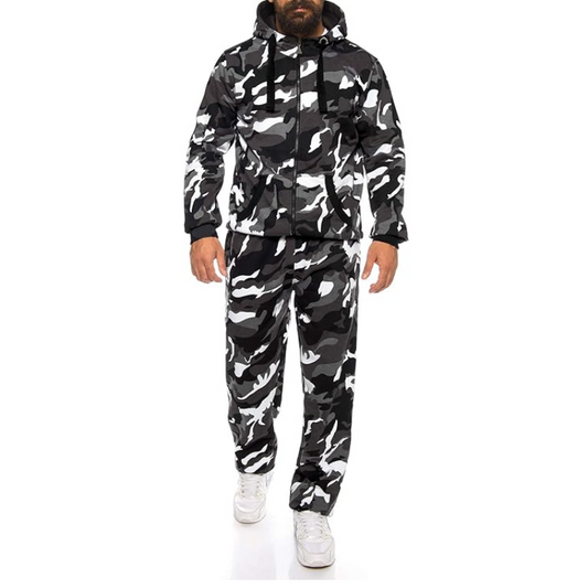 Person wearing a black and white camouflage jacket and pants set on a white background