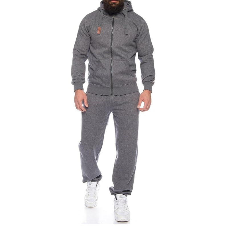 Person wearing a gray tracksuit with a white background
