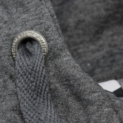 Close-up of a textured gray fabric with a metal ring and 'Norseman' branding.