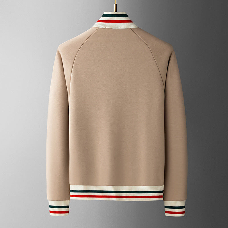 Beige sweater with striped cuffs and collar on a gray background