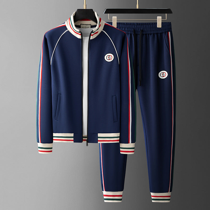 Navy tracksuit with red and white accents on a gray background