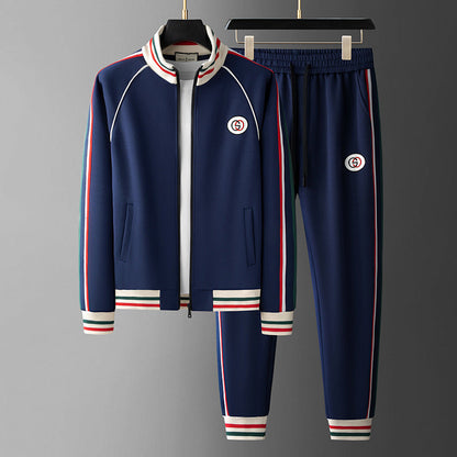 Navy tracksuit with red and white accents on a gray background