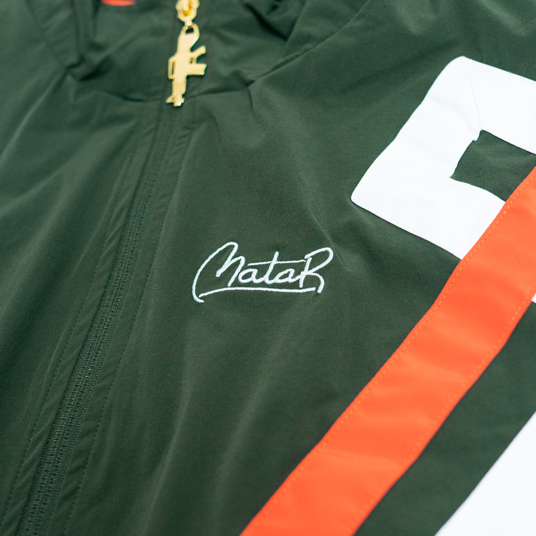 Green jacket with orange stripe and white logo on a white background