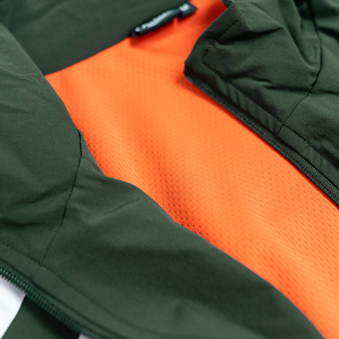 Close-up of a green and orange jacket with a zipper.