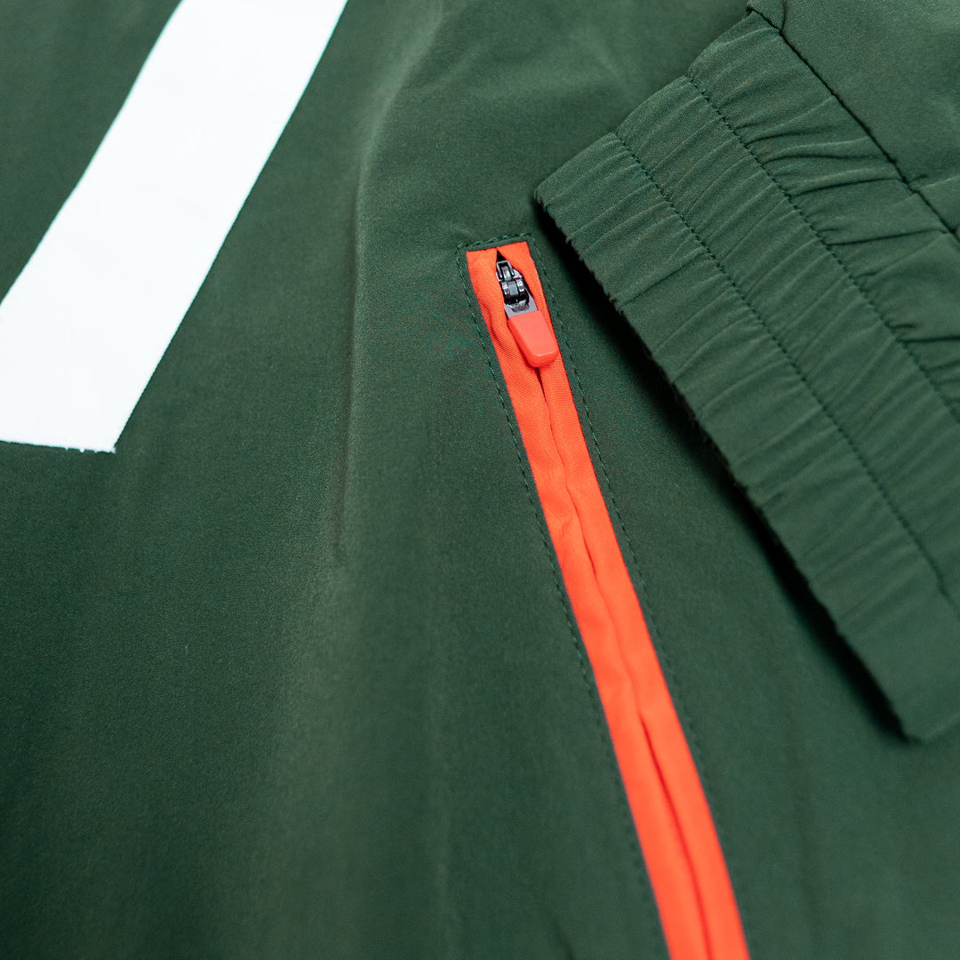 Close-up of a green jacket with an orange zipper