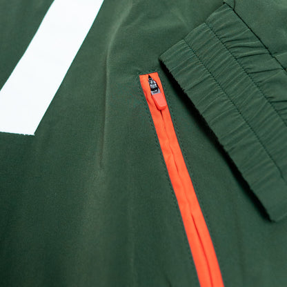 Close-up of a green jacket with an orange zipper