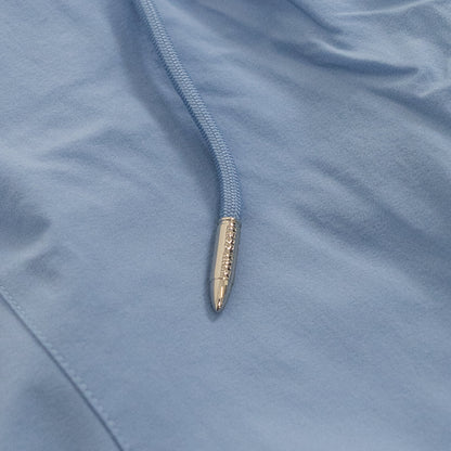 Close-up of a pen with a gold cap on a blue fabric background