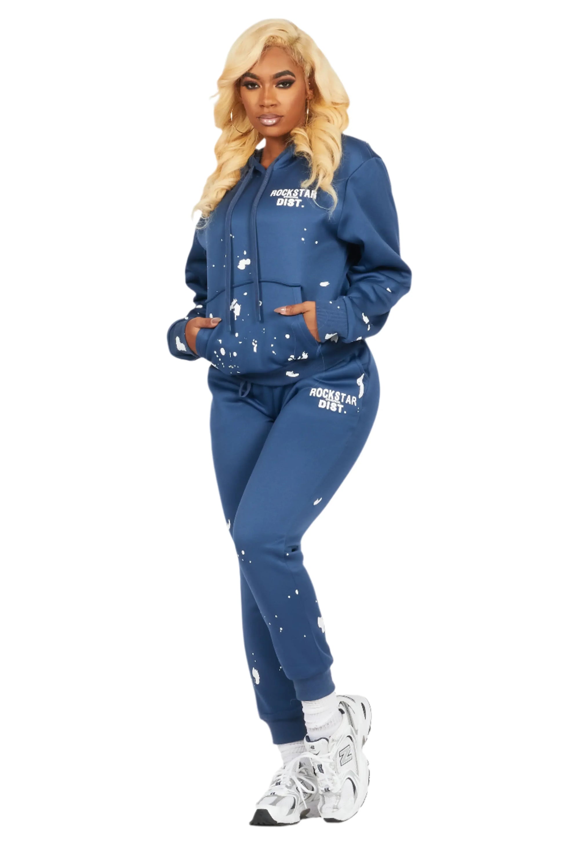 Woman wearing a blue tracksuit with white text and designs on a white background