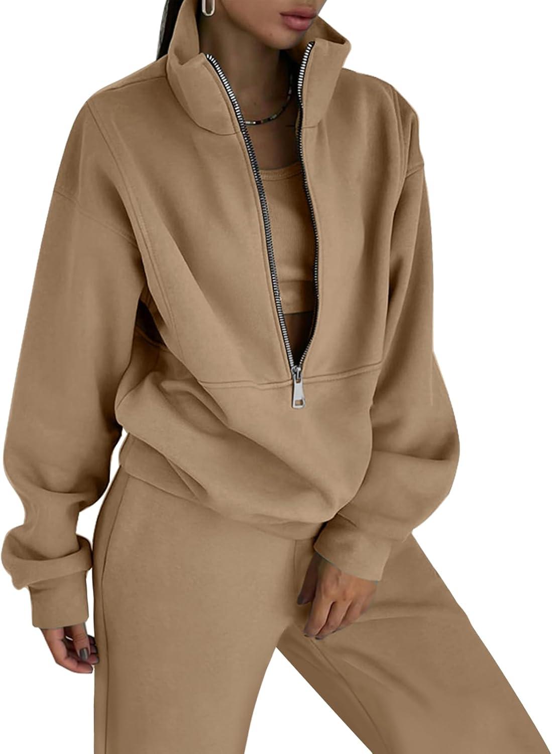 Beige tracksuit worn by a person on a white background