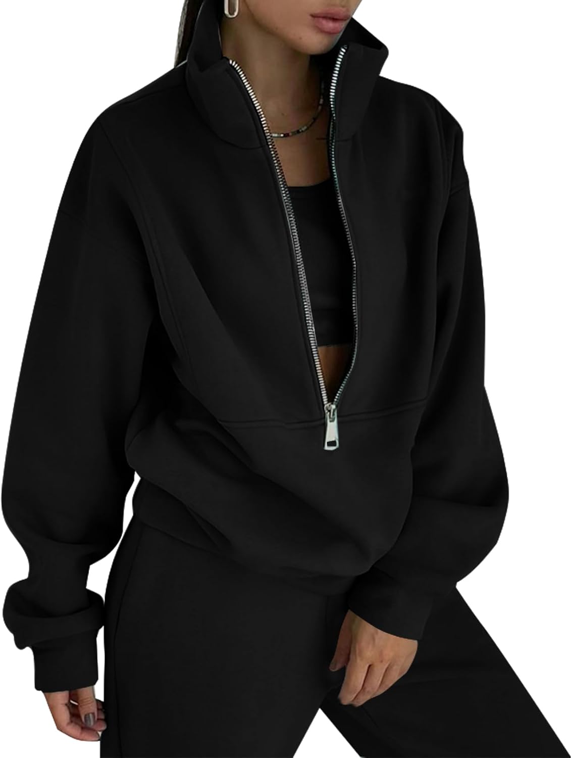 Black zip-up hoodie worn by a person on a white background