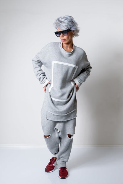 Person wearing a gray outfit with red shoes on a white background