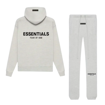 Gray hoodie and pants set with 'ESSENTIALS FEAR OF GOD' text on a white background