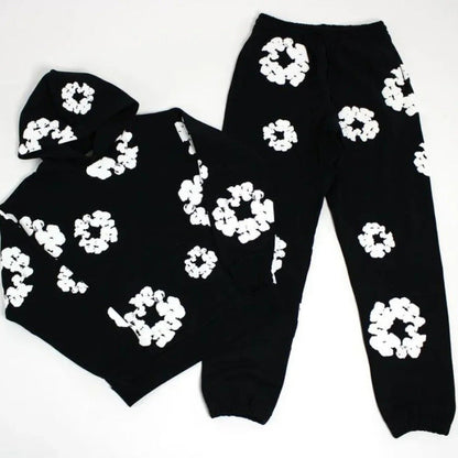Black hoodie and pants with white floral patterns on a white background