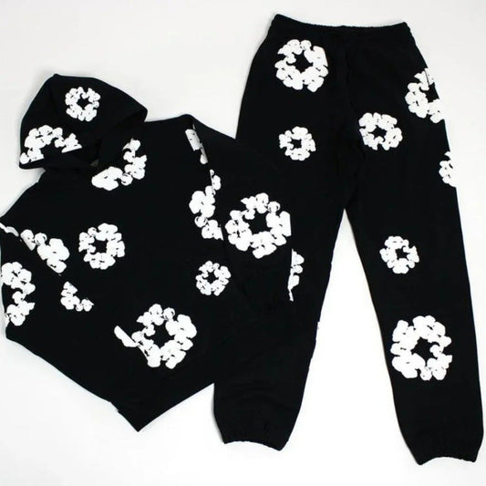 Black hoodie and pants with white floral patterns on a white background