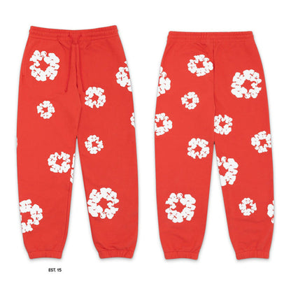 Red sweatpants with white floral patterns on a white background