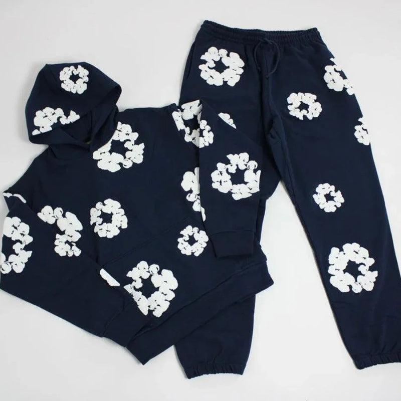 Navy blue loungewear set with white floral patterns on a light gray background