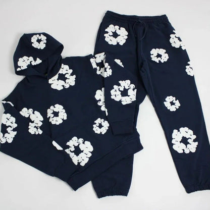 Navy blue loungewear set with white floral patterns on a light gray background