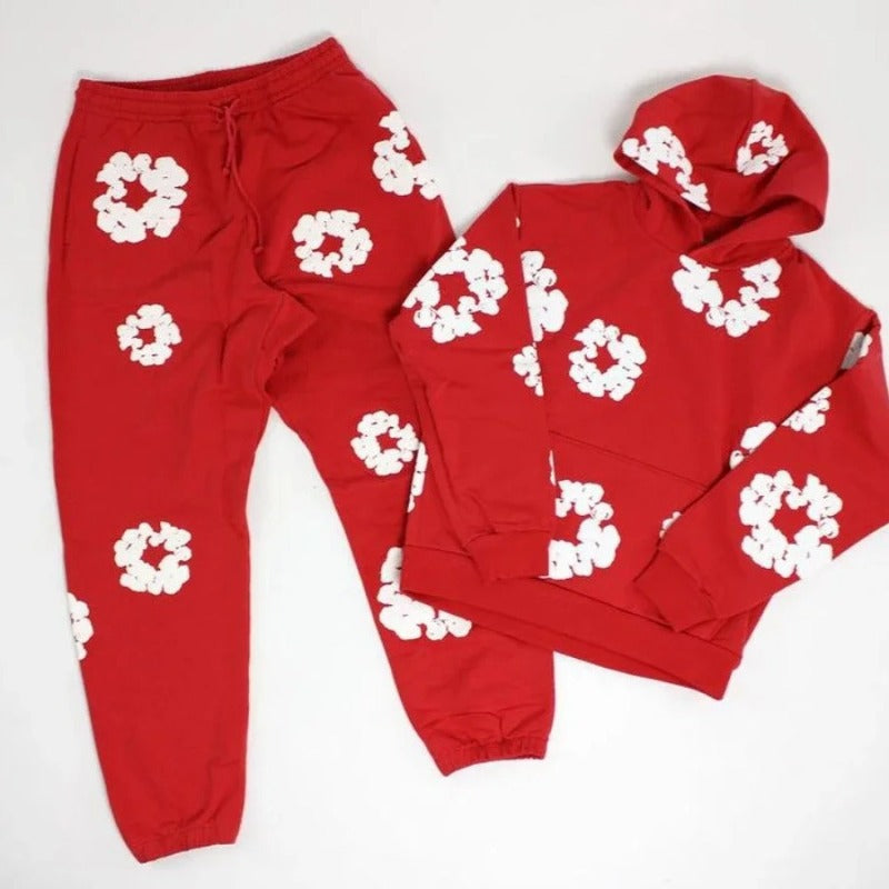 Red hoodie and sweatpants set with white floral patterns on a white background