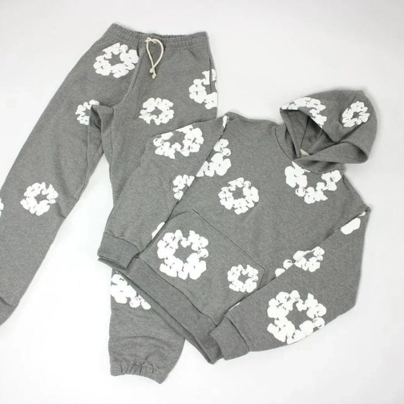 Gray hoodie and sweatpants set with white floral patterns on a white background