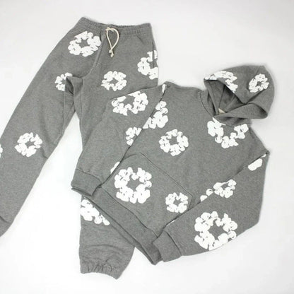 Gray hoodie and sweatpants set with white floral patterns on a white background