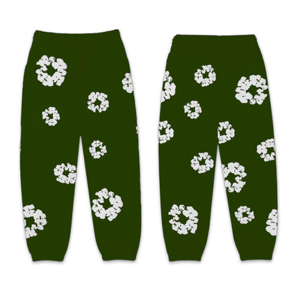 Green pants with white floral patterns on a white background
