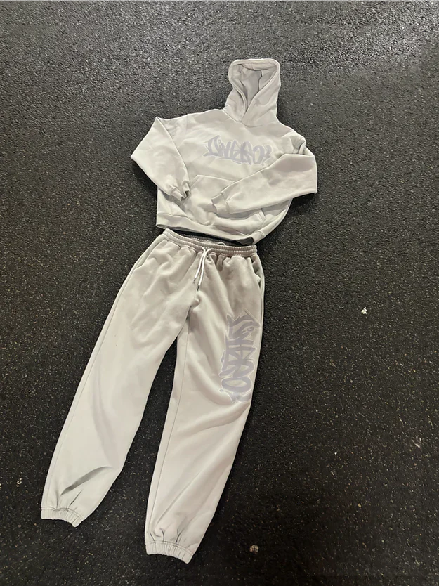 Light gray hoodie and jogger pants set on a dark surface