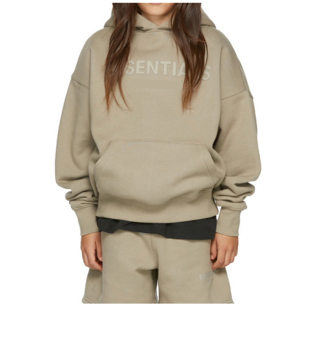 Person wearing a beige hoodie with 'SENTINEL' branding on a white background