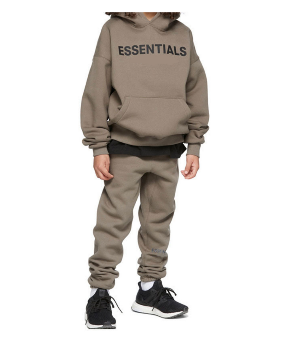 Person wearing a beige 'ESSENTIALS' hoodie and pants on a white background