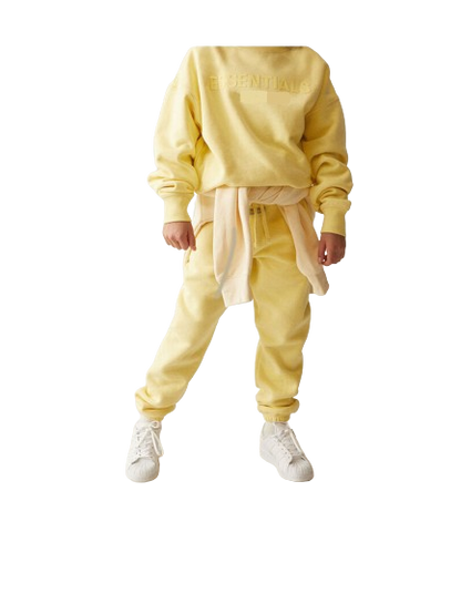 Person wearing a yellow tracksuit with a white background