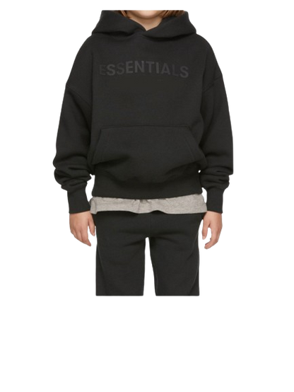 Person wearing a black hoodie with 'ESSENTIALS' text on a white background