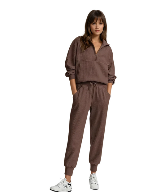 Woman wearing a brown tracksuit on a white background