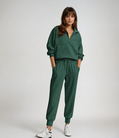 Woman wearing a green tracksuit on a white background