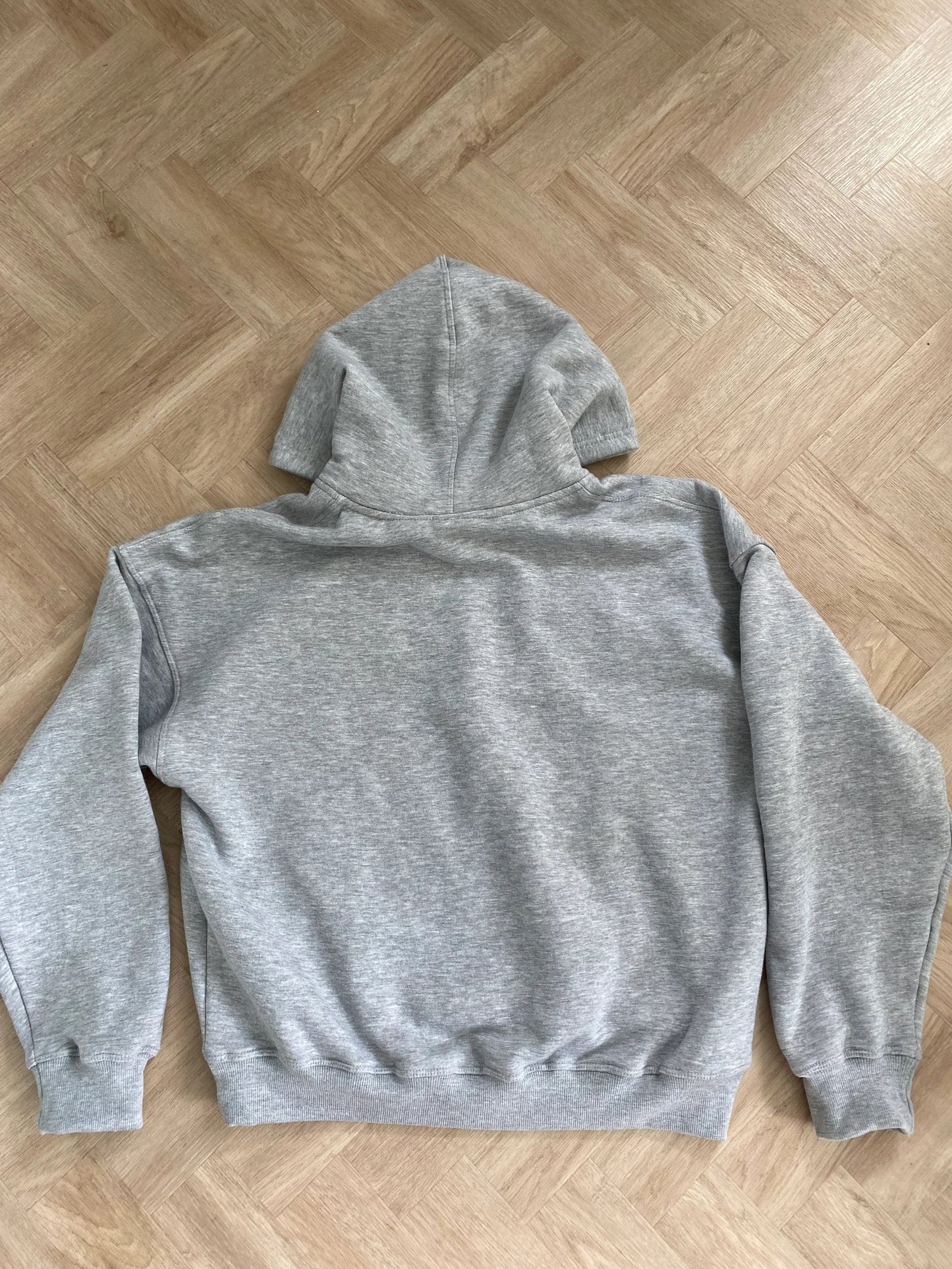 Gray hoodie on a wooden floor