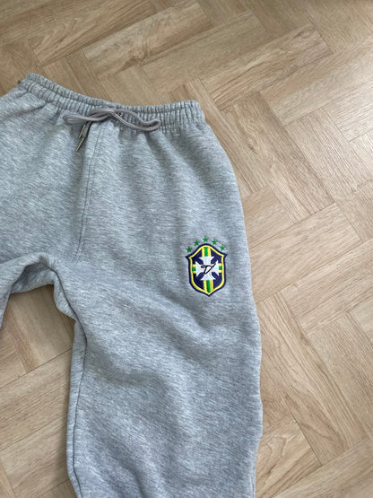Gray sweatpants with a logo on a wooden floor