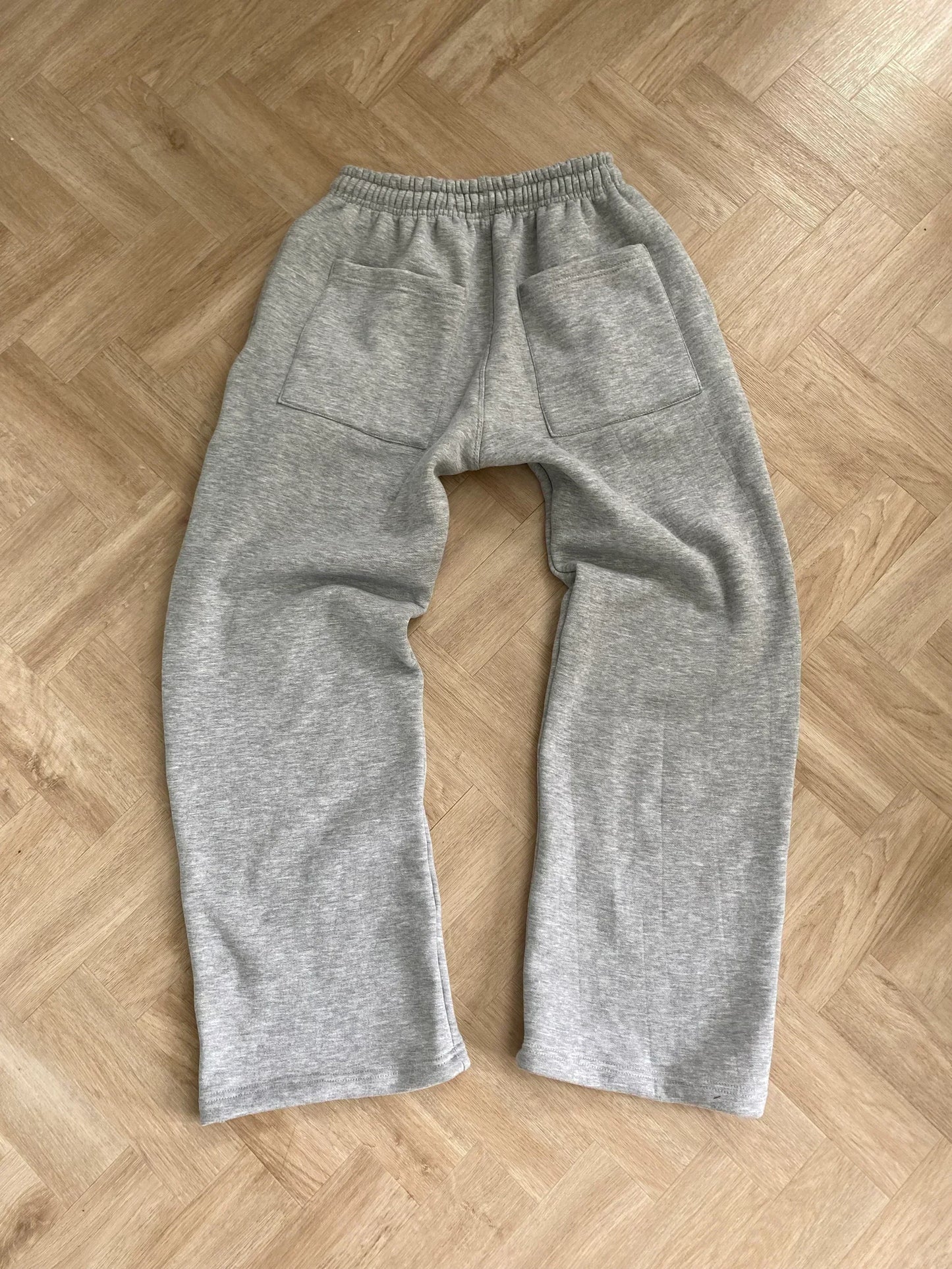Gray sweatpants on a wooden floor