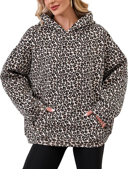 Person wearing a leopard print hoodie on a white background
