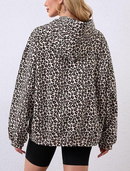 Person wearing a leopard print jacket on a plain background