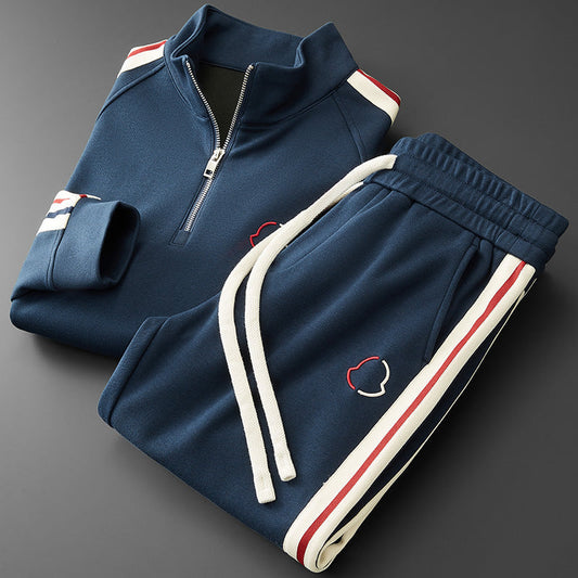 Navy tracksuit with white and red accents on a dark gray background