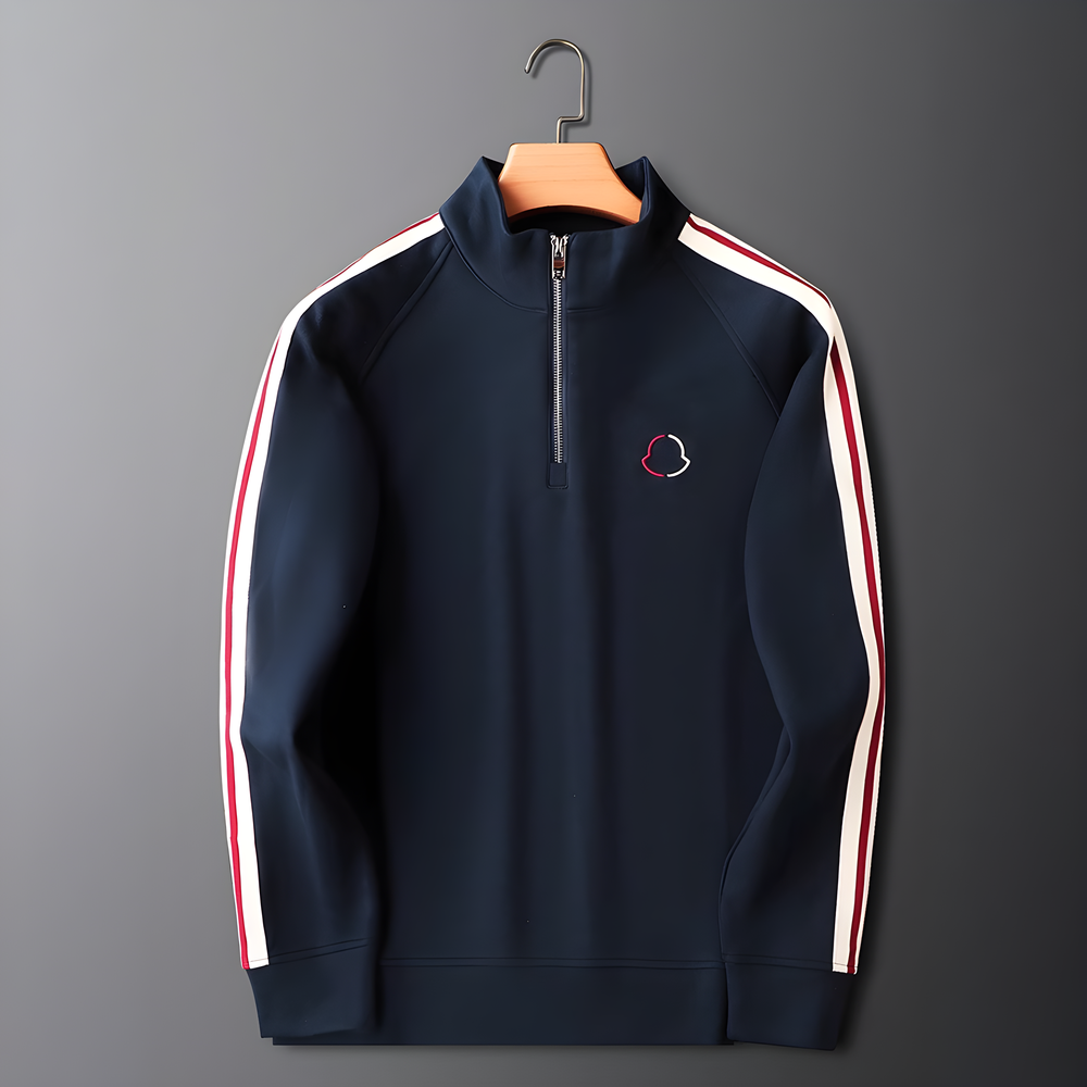 Navy blue half-zip sweatshirt with white and red stripes on a gray background