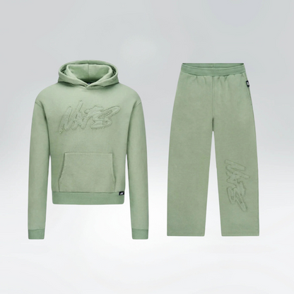 Green hoodie and pants set on a light gray background